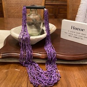 Substantial purple beaded mutual strand necklace